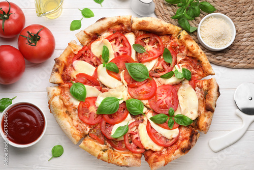 Delicious Caprese pizza on white wooden table, flat lay