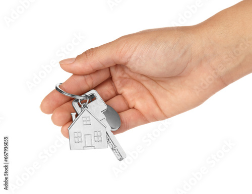 Slika na platnu Woman holding key with metallic keychain in shape of house on white background,