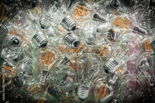 Light bulbs Incandescent vignette background , lighting , many, background texture glass , flatlay .concept saving resources power ,substitution with diodes, prohibition of the use of incandescent lam
