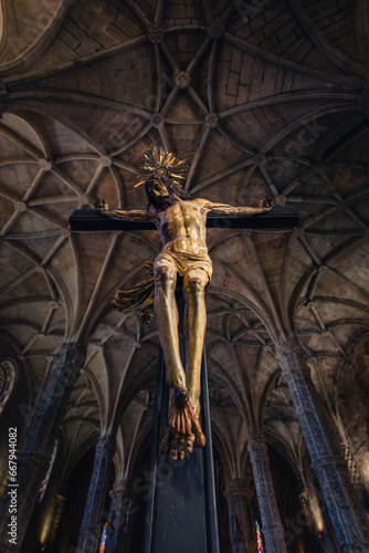 Painted wooden sculpture of Jesus Christ being crucified