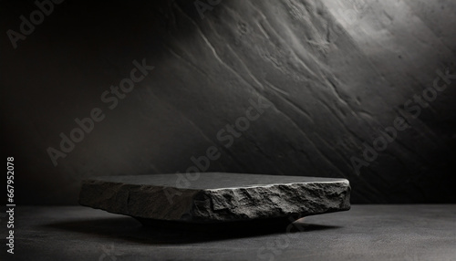 Black stone pedestal or platform on dark background. High quality photo