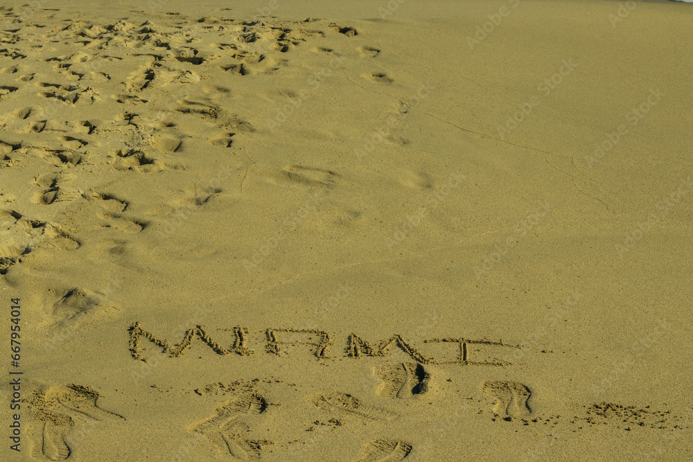 Fototapeta premium footprints in sand with the word miami written on, miami florida usa