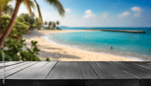 Wooden black table top on blur tropical beach background - can be used for display or montage your products. High quality photo
