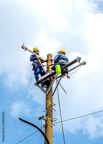 Принти на полотні Workers are repairing electricity on overhead poles in Ho Chi Minh City, Vietnam