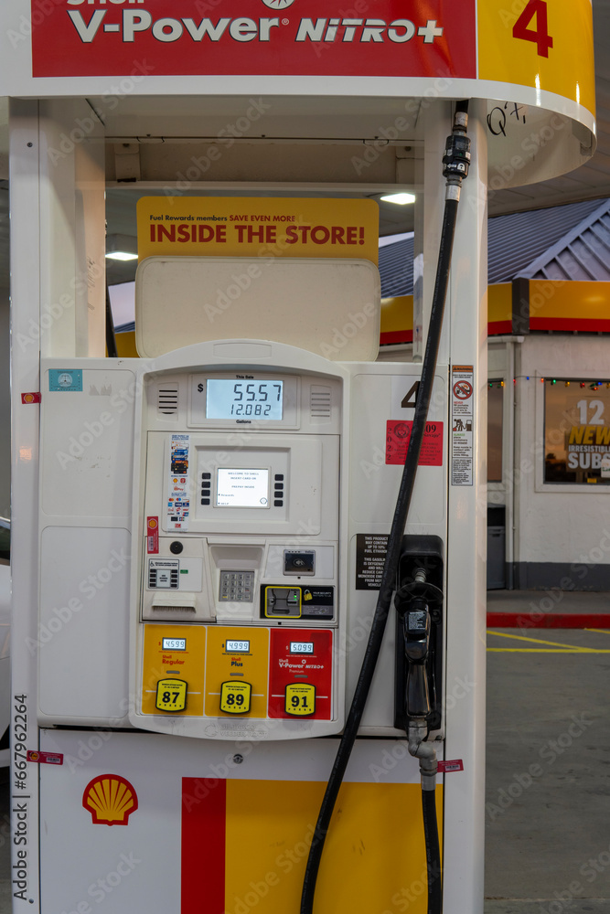 Shell gas pump nozzle in a service station. Close up fuel nozzle at