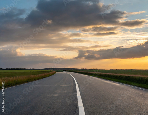 Evening light, a flat, large asphalt road stunning sky at twilight. High quality photo