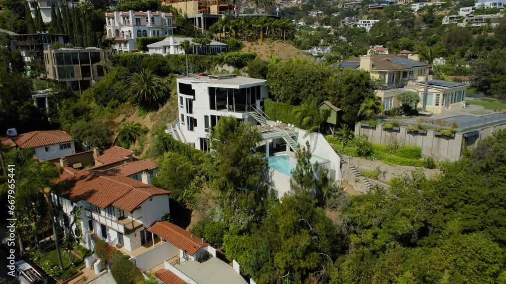 Aerial Forward Shot Of Houses Amidst Plants And Trees On Hills Against Sky - West Hollywood, California Aerial Forward Shot Of Houses Amidst Plants And Trees On Hills Against Sky - West Hollywood, California