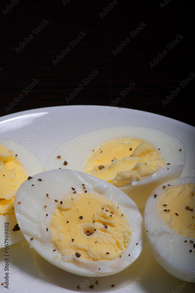 Boiled eggs with seasoned black pepper in plate Boiled eggs with seasoned black pepper in plate