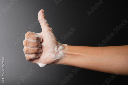 Foamy hand thumbs up gesture, hand wash concept