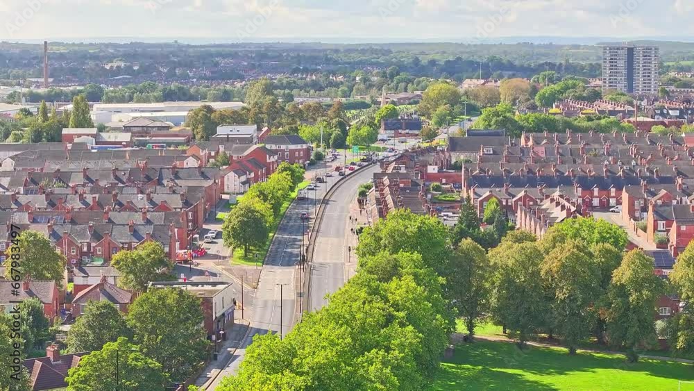 Drone rises above bend in the road between suburban neighborhood in Doncaster England Drone rises above bend in the road between suburban neighborhood in Doncaster England