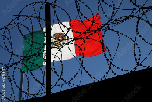 Barbed wire and flag of Mexico photo