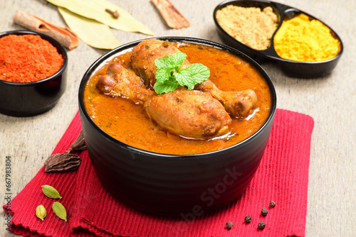 Indian style spicy chicken curry in bowl