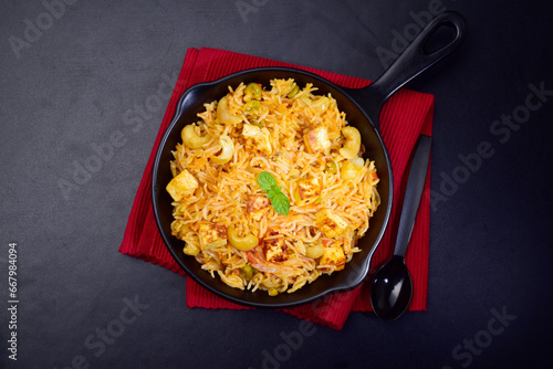 Matar paneer pulao in plate on dark background, indian food photo