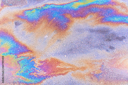 Abstract background from motor oil, gas or petrol spilled on asphalt