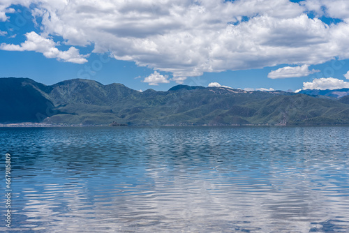 The reflection of blue sky and white clouds on the water surface of Lugu Lake in China