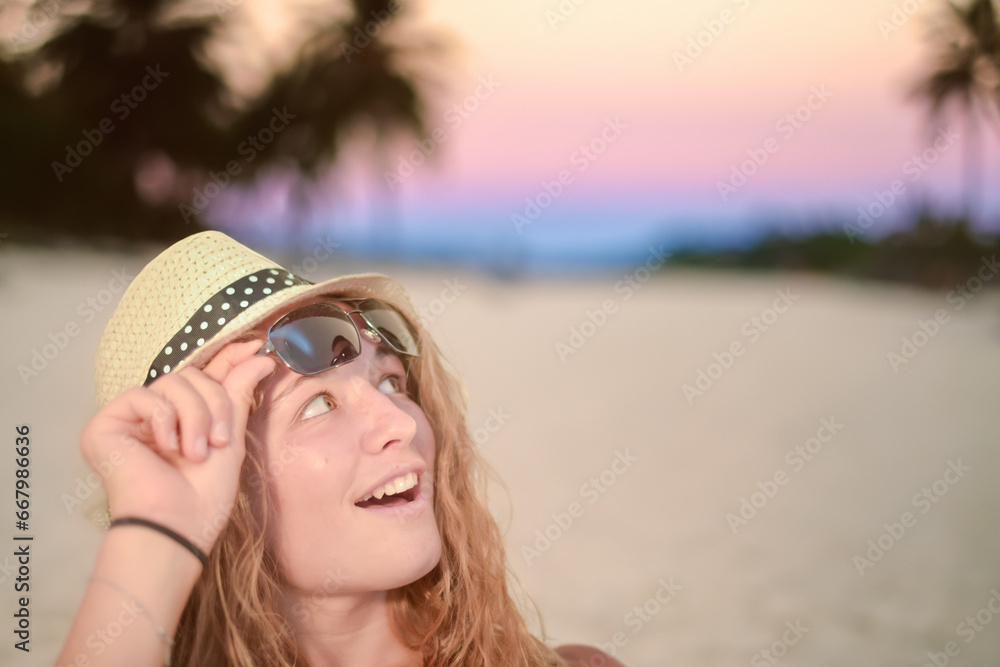 Pretty young woman on a tropical beach at sunset
