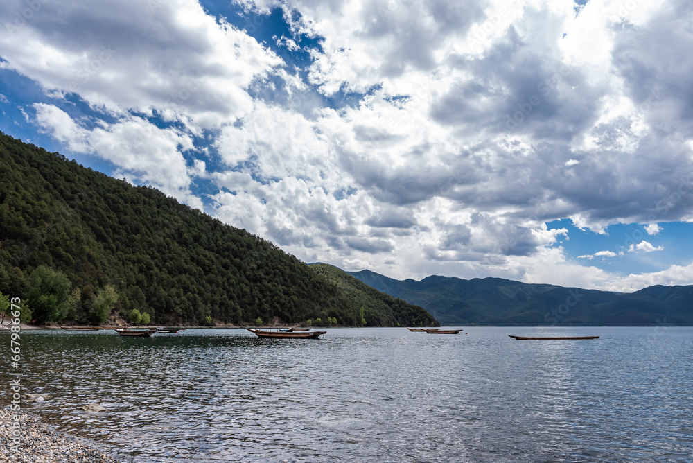 The beautiful scenery of Lugu Lake in China under the blue sky and white clouds