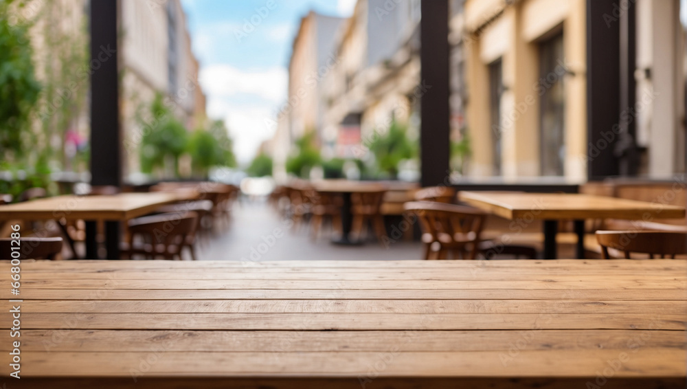 Fototapeta premium empty wooden desk cafe with blurred background of city street