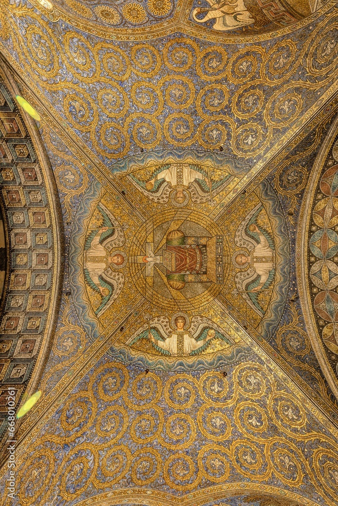 Ornately decorated domed ceiling with gold-painted accents inside the Aachen Cathedral in Germany