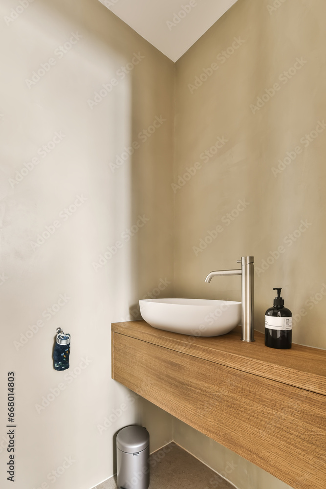 a bathroom with a sink and toilet paper dispensed on the wall next to the washbast