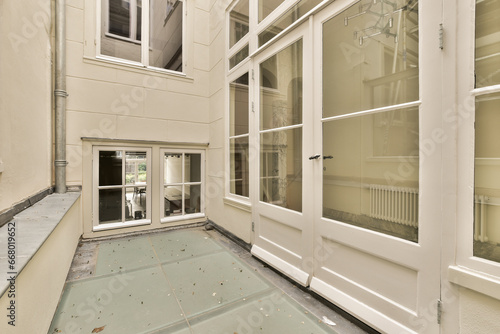 the inside of a building with broken windows and debris scattered on the ground in front of the door to the room