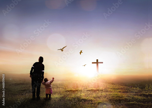 Silhouette people looking for the cross on autumn sunrise background
