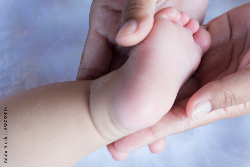 Baby feet in hand, mother, tiny newborn baby feet on hand, female photo, closeup, mother and her child, happy family concept, beautiful concept image of childbirth. Baby feet in hand, mother, tiny newborn baby feet on hand, female photo, closeup, mother and her child, happy family concept, beautiful concept image of childbirth.