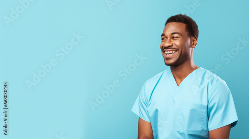 Friendly medical doctor or nurse in blue uniform scrubs on copyspace background. photo
