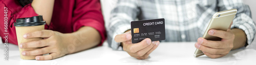 E-commerce Concept. Happy couple holding credit card enjoying doing online shopping and using laptop enter their card number in-app to purchase and payment in internet store