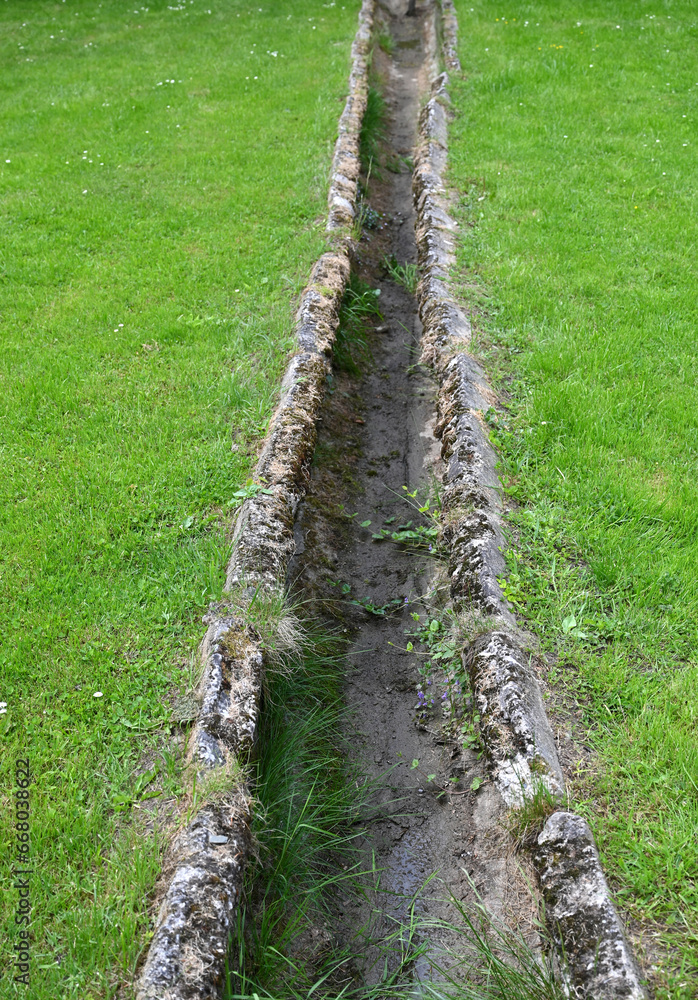 Old stone paved road water ditch
