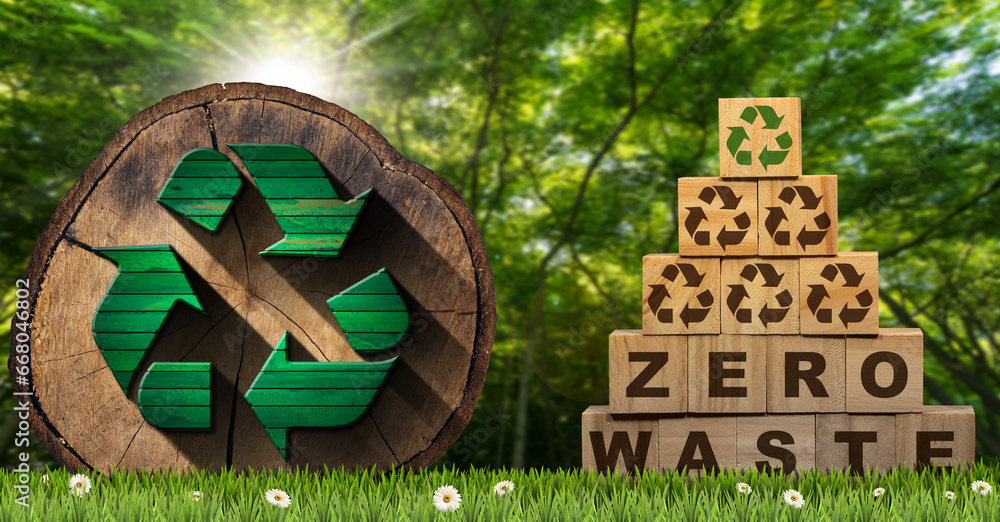 Φωτογραφία Stack of wooden blocks with text Zero Waste and Recycling Symbols, on a green meadow with a cross section of a tree trunk with a recycle symbol and a green forest on background