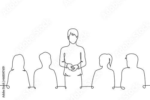 man stands in the middle of people sitting next to him at the table who are listening to him - one line art vector. concept man making a toast, speech at a dinner party or conference