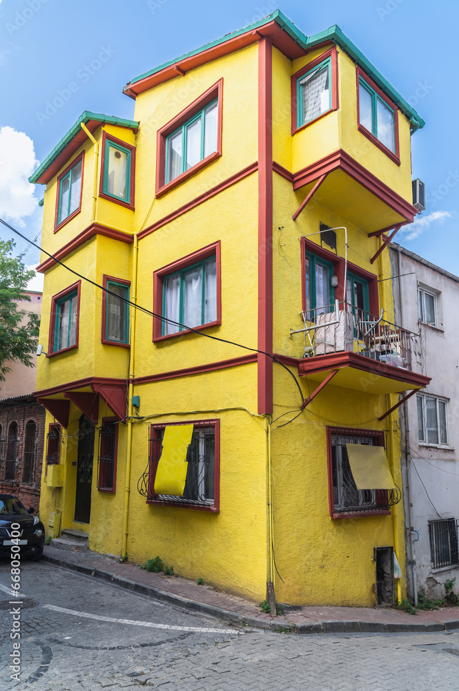 Yellow house in the historical district of Fatih Balat, Istanbul. Narrow old city streets.