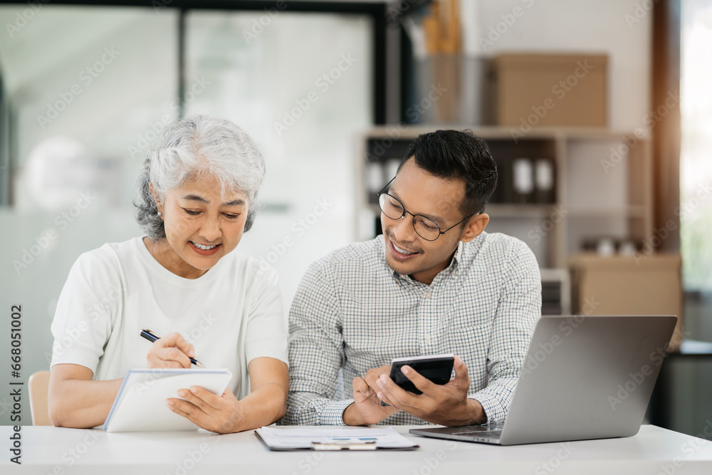 Business team take notes and use the calculator with calculations about the expenses at the office. Business team take notes and use the calculator with calculations about the expenses at the office.