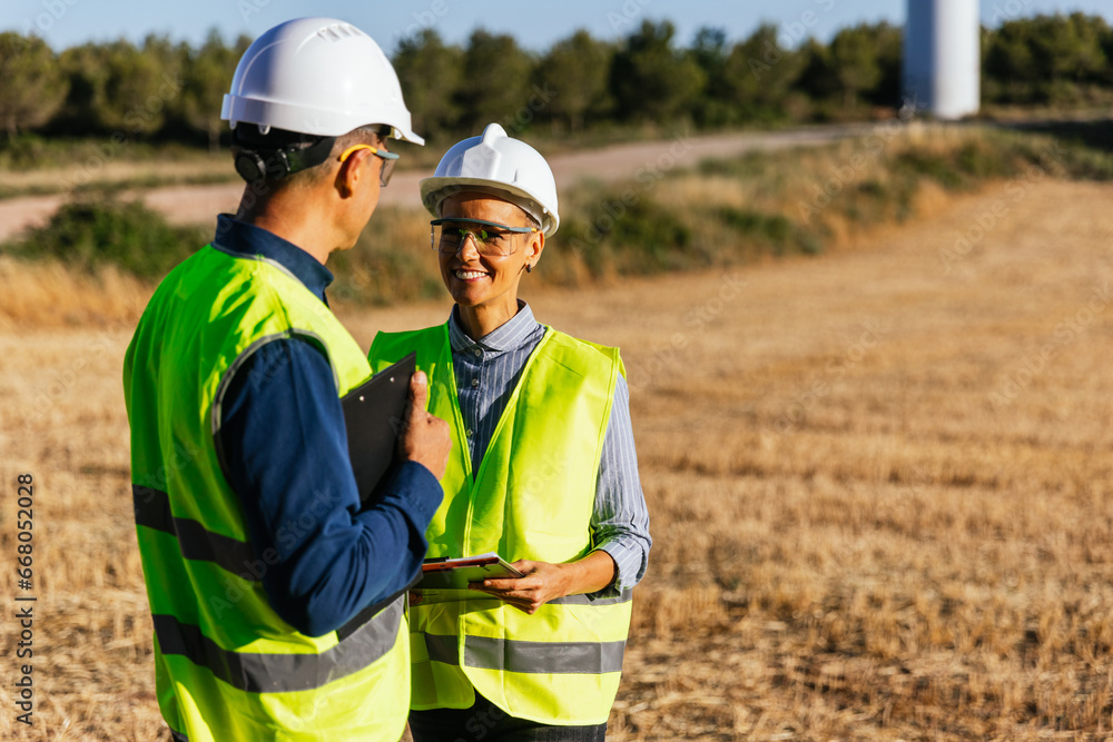 Optimistic engineers at work on a windmill farm. Optimistic engineers at work on a windmill farm.