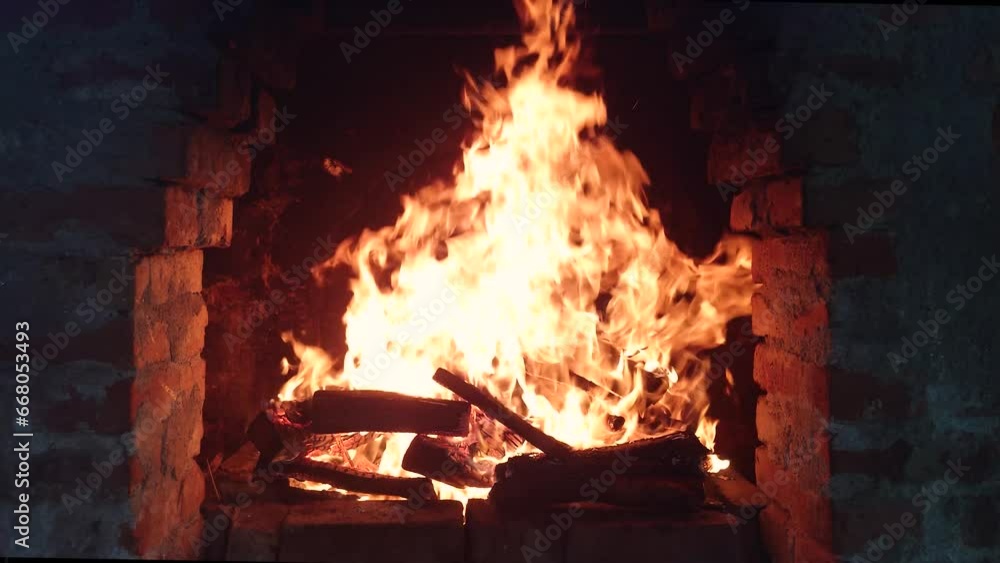 Open fire with tall flames inside outdoor rustic grill oven and grid. Firewood burning hot, real time, no people Open fire with tall flames inside outdoor rustic grill oven and grid. Firewood burning hot, real time, no people