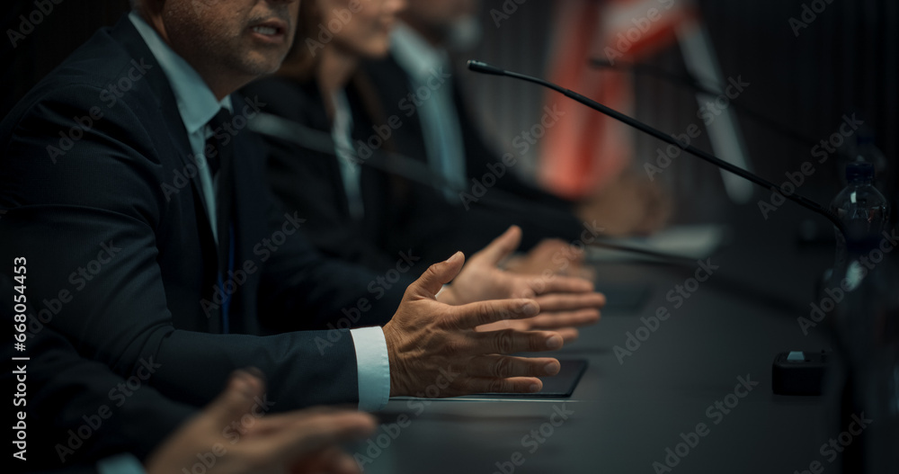 Close Up On Hands of Caucasian Male Organization Representative Speaking at Economic Conference. Head Of USA Delegation Delivering Speech at International Political Summit. Diverse Delegates Listening - obrazy, fototapety, plakaty 