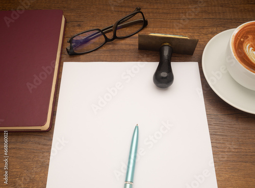 Top view of a blank paper on office desk table.