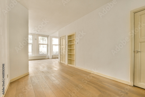 an empty room with wood flooring and white paint on the walls  there is no one person in it