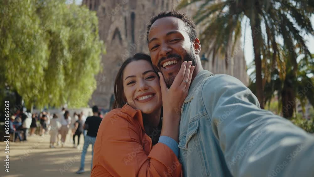 Young multiethnic couple visiting and dating in the center of Barcelona. Travelers on vacation exploring the city and the main landmarks and famous places Young multiethnic couple visiting and dating in the center of Barcelona. Travelers on vacation exploring the city and the main landmarks and famous places