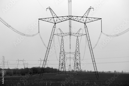 High voltage electric power line towers (black and white) photo