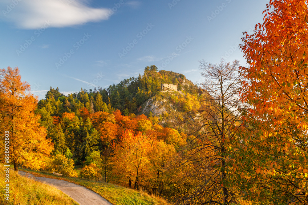 View of autumn landscape with The ruin of the medieval Vrsatec castle at sunset. The Vrsatec National Nature Reserve in the White Carpathian Mountains, Slovakia, Europe.