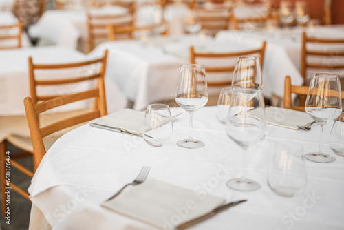 Tables with clean dishes in the restaurant are set for receiving guests - siesta and the restaurant is closed © andrey gonchar