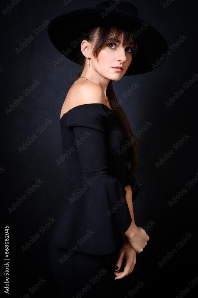 Elegant Woman in Black Hat and Off-Shoulder Dress