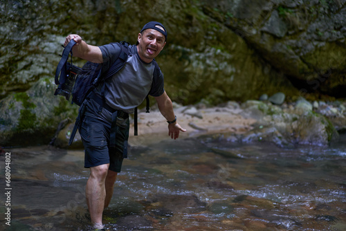 Photographer with backpack in a gorge