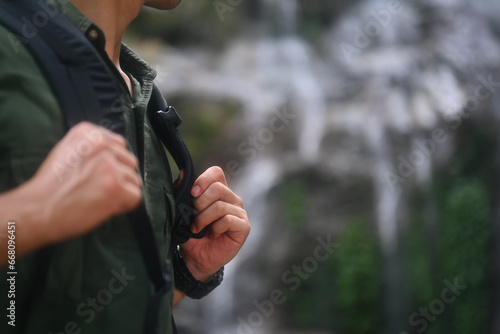 Male hiker with backpack trekking in forest and exploring nature. Travel, adventure and active life concept
