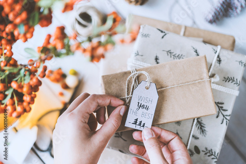 Woman hands gift wrapping Christmas presents, wish you the best