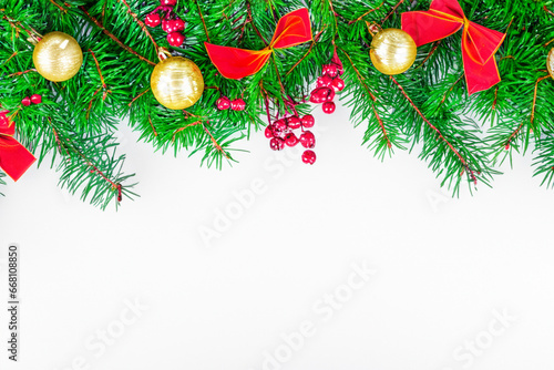 Christmas white background with Christmas tree branches and Christmas decorations. Beautiful festive background for Christmas greeting card