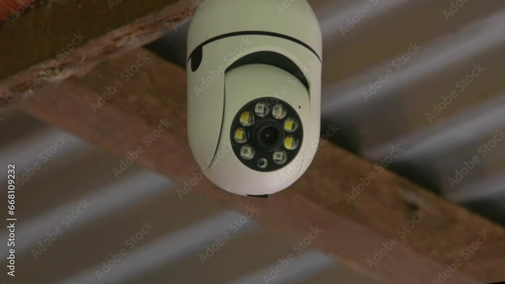 A CCTV camera installed on the street moves and monitors security A CCTV camera installed on the street moves and monitors security