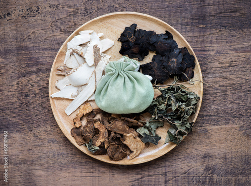 Fragrant bag to cure sleepiness and add freshness Ingredients: patchouli, angelica dahurica and other herbs on an old wood background. photo